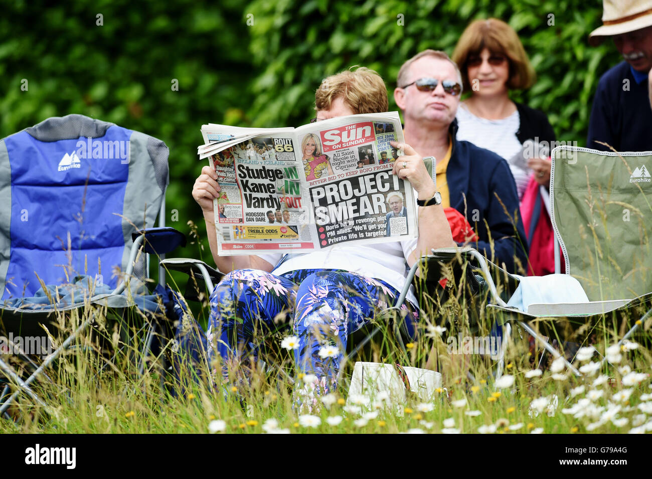 Arundel West Sussex UK 26th June 2016 - A woman reads the Sun on Sunday newspaper at Arundel in warm sunny weather today after the vote to leave the European Union has left Britain spilt  Credit:  Simon Dack/Alamy Live News Stock Photo