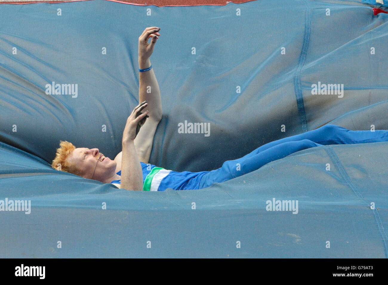 Pole vault athlete falls onto the crash mat during Stock Photo Alamy