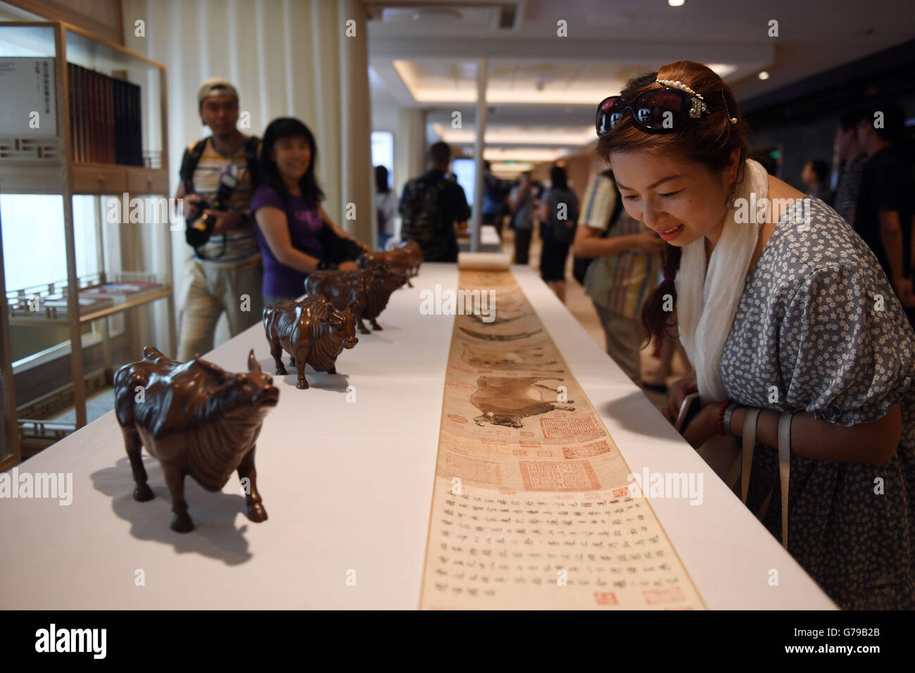 Tianjin. 26th June, 2016. A woman looks at cultural products of the Palace Museum on Royal Caribbean's cruise ship Ovation of the Seas during a cultural activity in north China's Tianjin Municipality, June 26, 2016. © Jin Liangkuai/Xinhua/Alamy Live News Stock Photo