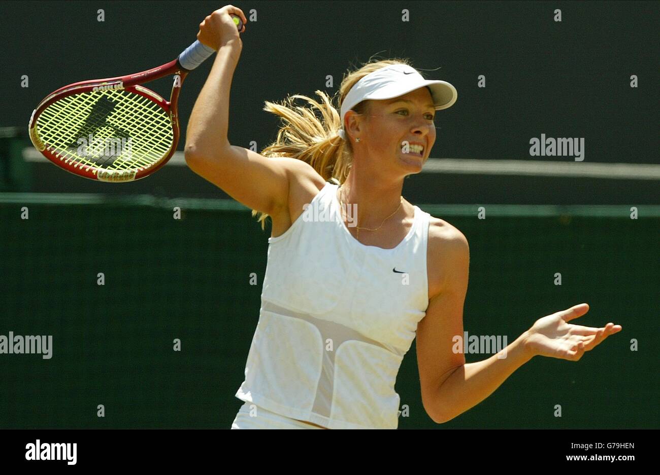 Maria Sharapova from Russia in action against Jelena Dokic from Serbia Montenegro in the third round at the All England Lawn Tennis Championships at Wimbledon. Stock Photo