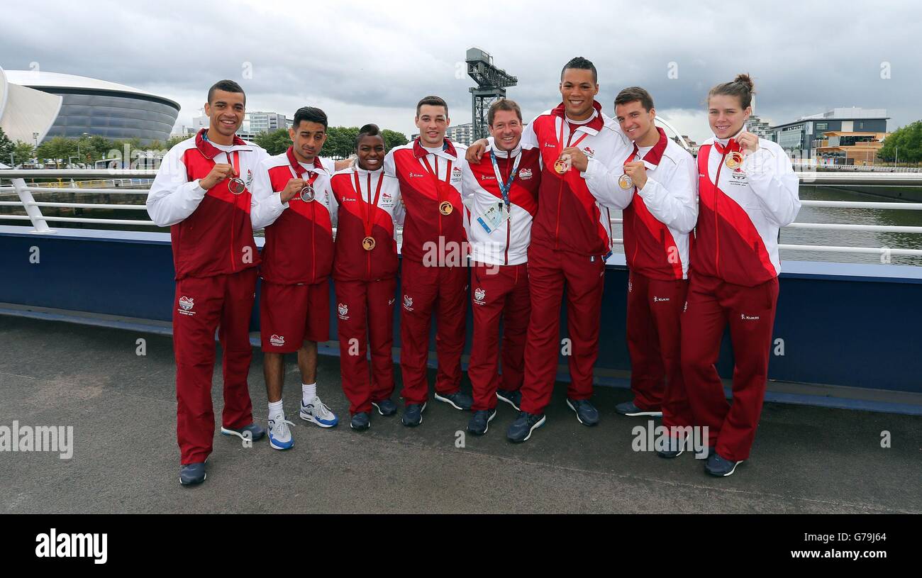 The seven England Boxers (left-right) Qais Ashfaq, Sam Maxwell, Joe Joyce, Nicola Adams, Scott Fitzgerald, Coach Lee Murgatroyd, Joe Joyce, Anthony Fowler and Savannah Marshall with their medals the morning after the finals during a press conference at the MPC, during the 2014 Commonwealth Games in Glasgow. Stock Photo