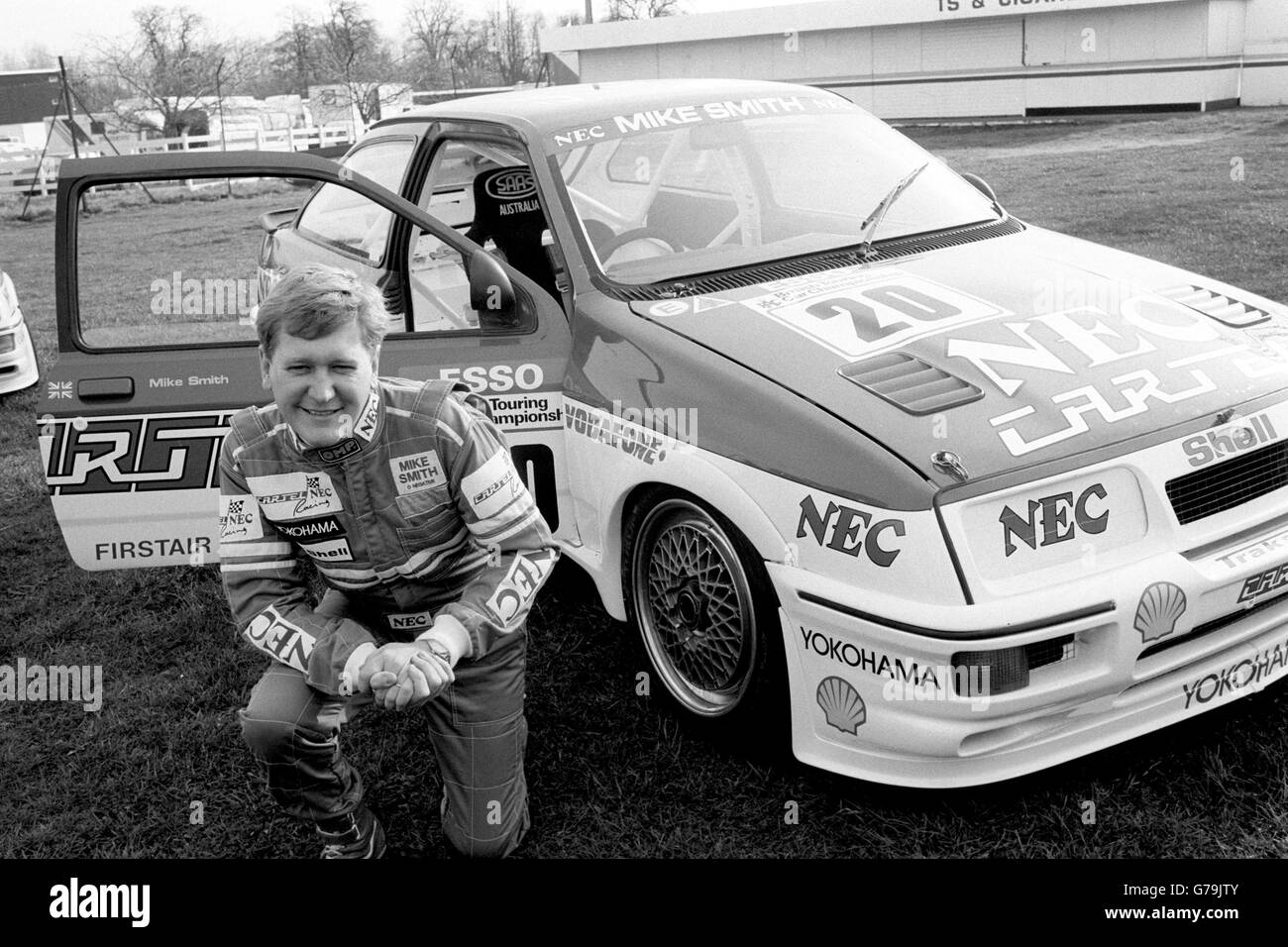 TV presenter Mike Smith poses with the 174mph Ford Sierra RS500 he is due to drive in the British Touring Car Championship. He flew into Oulton Park race circuit in a helicopter - the first time he has flown one since his near-fatal crash last year. Stock Photo