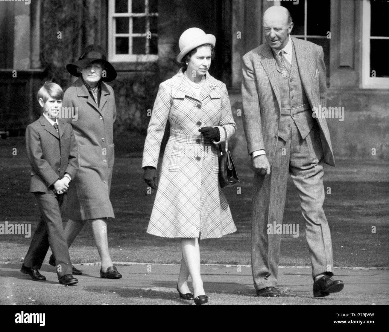The Queen is escorted to church by her host, the Duke of Beaufort. The Duchess follows behind with Prince Edward. Stock Photo