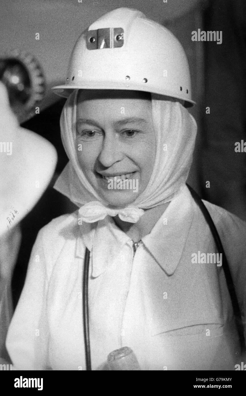 The Queen wearing white overalls and a safety helmet during a visit to Silverwood Colliery near Rotherham. Stock Photo