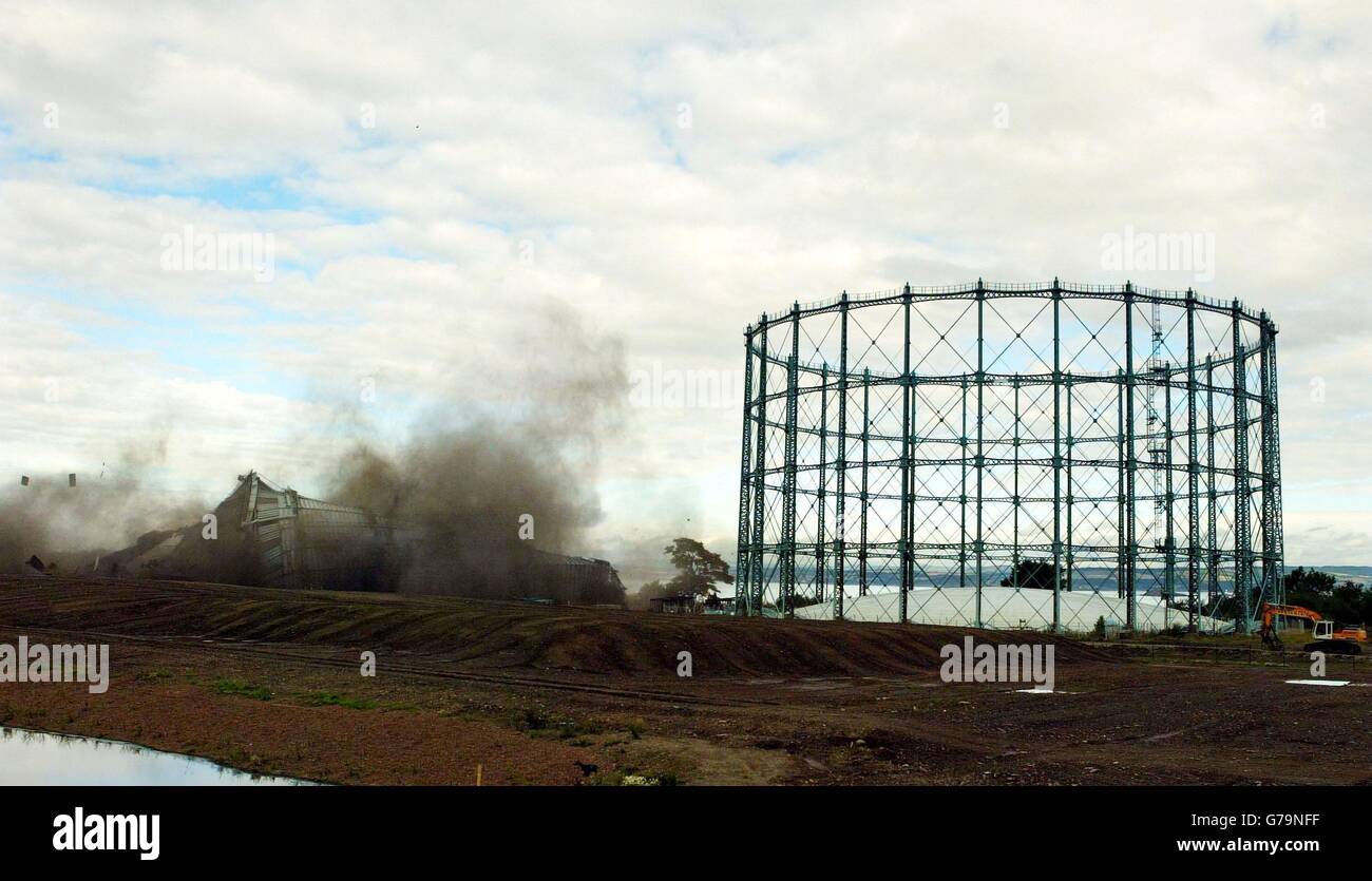 Fifth in a set of five photos. The 275ft gas holder (left) at the old Granton gasworks site in Edinburgh structures being demolished by a controlled explosion. The gas holder which was one of Edinburgh's tallest industrial structures has been demolished to make way for the redevelopment of the 110-acre site which is a key focus of the city's waterfront urban regeneration project. Stock Photo