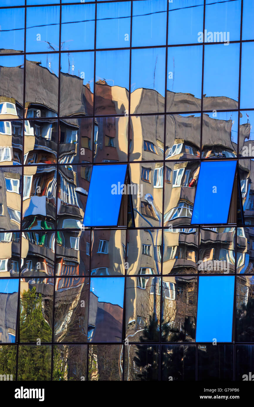 new window with a mirror coating reflects near-standing building Stock Photo