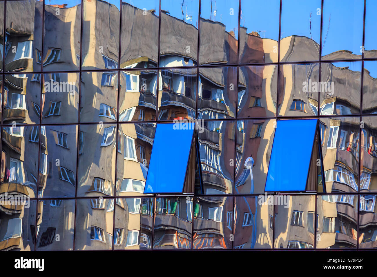 new window with a mirror coating reflects near-standing building Stock Photo