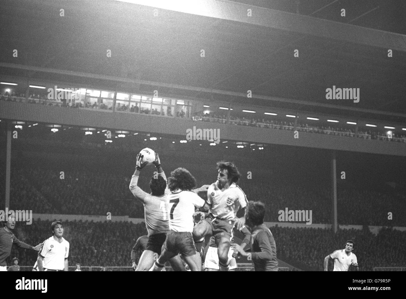 Italian goalkeeper Dino Zoff safely picks out a dangerous cross despite the attentions of England players Kevin Keegan (No 7) and Dave Watson during the World Cup qualifier at Wembley. Stock Photo