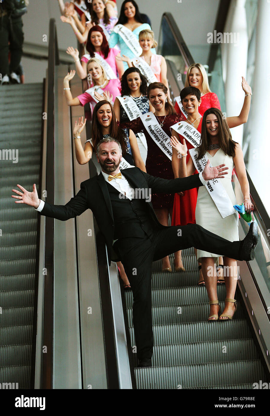 Host Daithi O Se with some of the 32 Irish and International Roses taking part in the 2014 International Rose Selection at the launch of this years Rose of Tralee Festival at Dublin Airport. Stock Photo