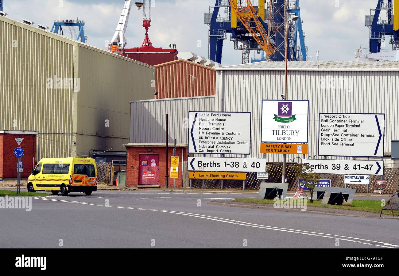 An ambulance van drives into Tilbury Docks in Essex, where a shipping container was found with illegal immigrants inside with one dead and the rest ill and taken to hospital. Stock Photo