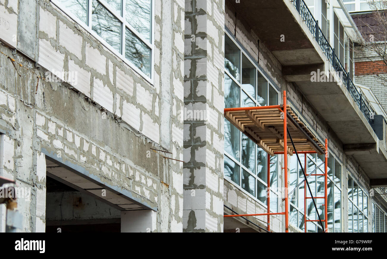 The facade of the building during the construction phase. Scaffolding ...
