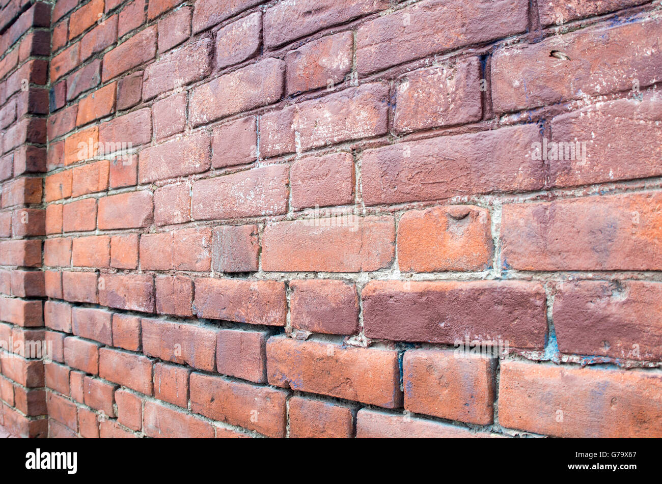 Selective focus on the red brick wall at an angle with a diffuse distal ...