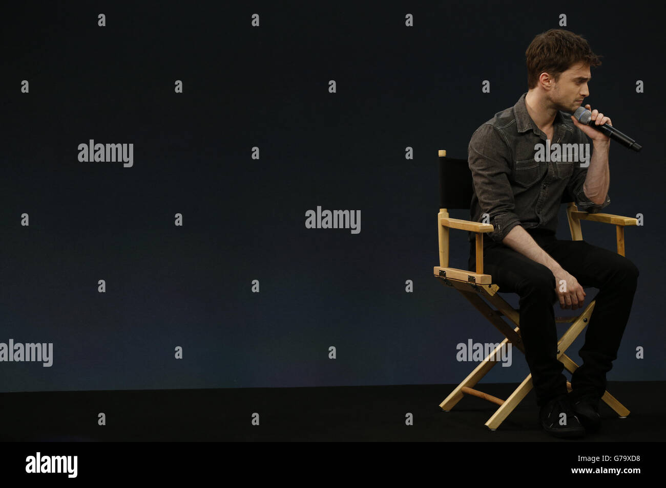 Daniel Radcliffe watches a video clip off stage during a question and answer session about the film 'What If' at the Apple Store, Regent Street, London. Stock Photo