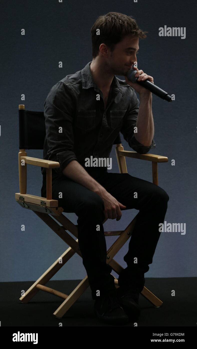 Daniel Radcliffe watches a video clip off stage during a question and answer session about the film 'What If' at the Apple Store, Regent Street, London. Stock Photo