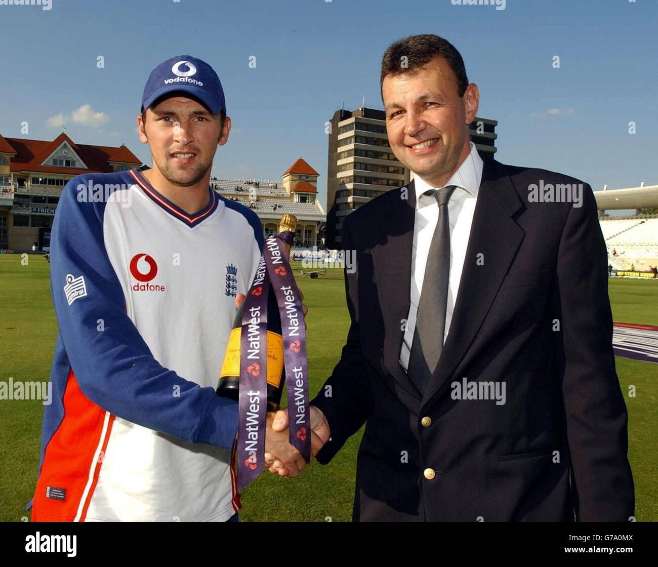 NatWest regional director Derek Brewer presents England's Stephen Harmison with champagne after his hatrick during the Natwest Challenge one day international between England and India at Trent Bridge, Nottingham. Stock Photo