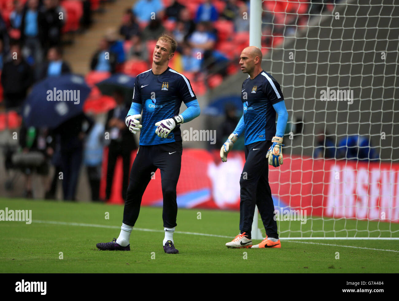 Manchester City goalkeeper Joe Hart during warm-up with team-mate Willy Caballero prior to the Community Shield match at Wembley Stadium, London. Stock Photo