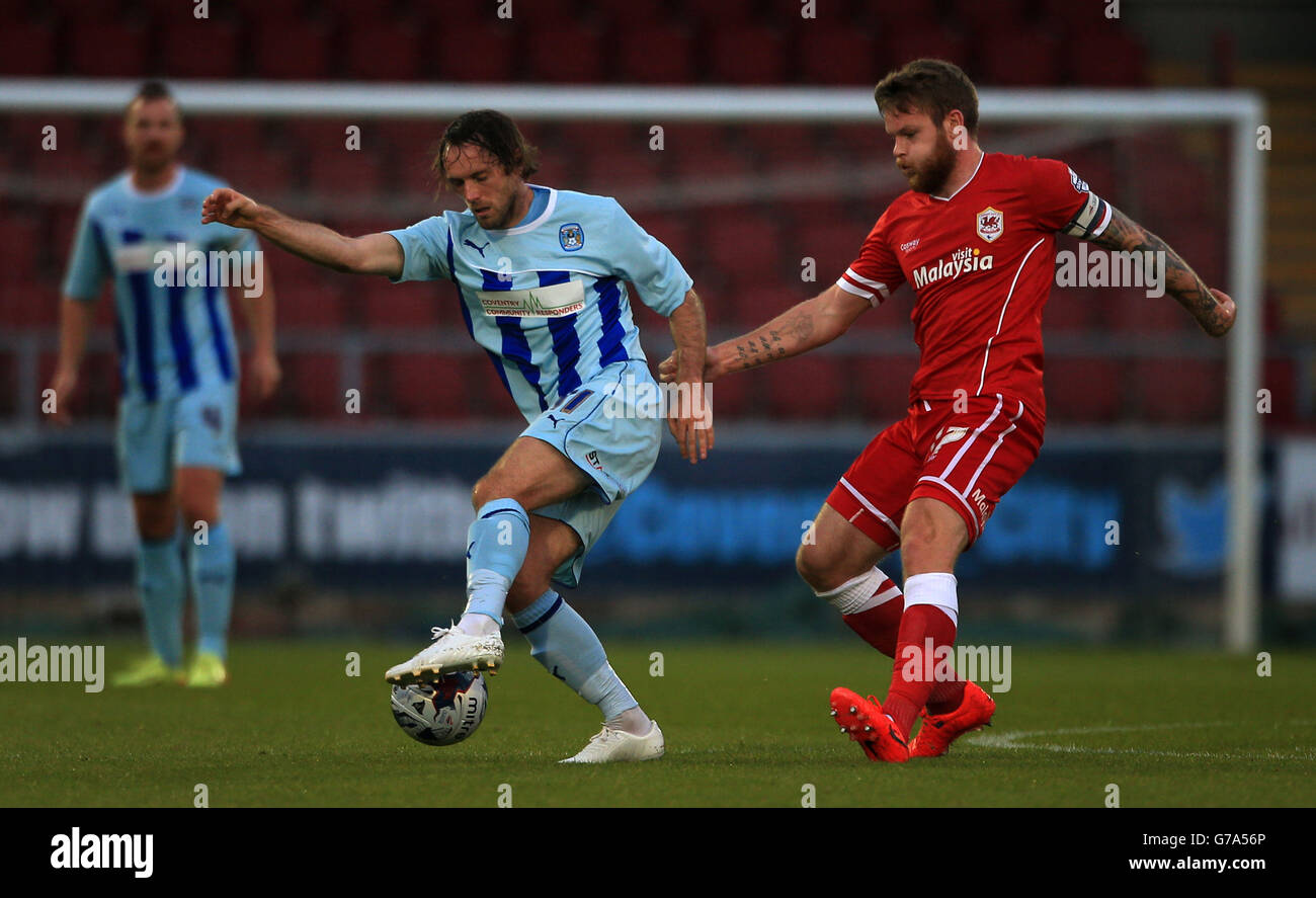 Coventry City's Jim O'Brien holds off challenge from Cardiff City's Aron Gunnarsson, during the Capital One Cup First Round match at Sixfields Stadium, Northampton. Stock Photo