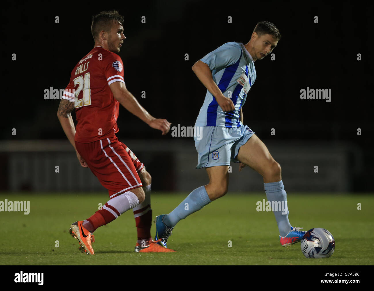 Coventry City's Shaun Miller battles with Cardiff City's Joe Ralls during the Capital One Cup First Round match at Sixfields Stadium, Northampton. Stock Photo