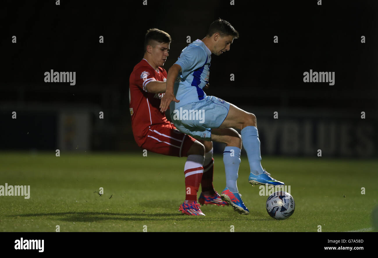 Coventry City's Shaun Miller battles with Cardiff City's Declan John during the Capital One Cup First Round match at Sixfields Stadium, Northampton. Stock Photo
