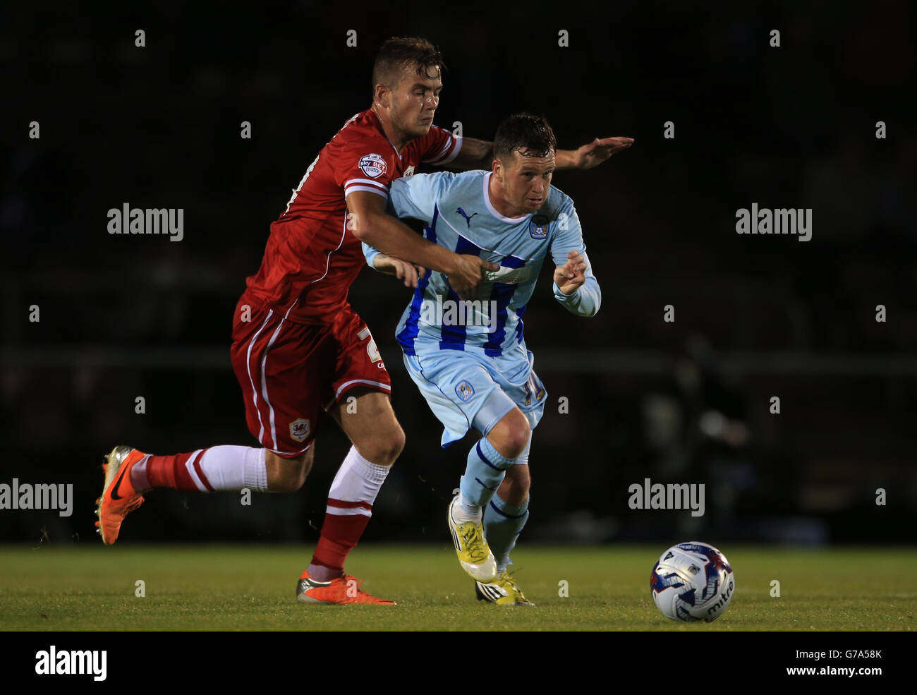 Coventry City's Danny Swanson breaks past Cardiff City's Joe Ralls, during the Capital One Cup First Round match at Sixfields Stadium, Northampton. Stock Photo
