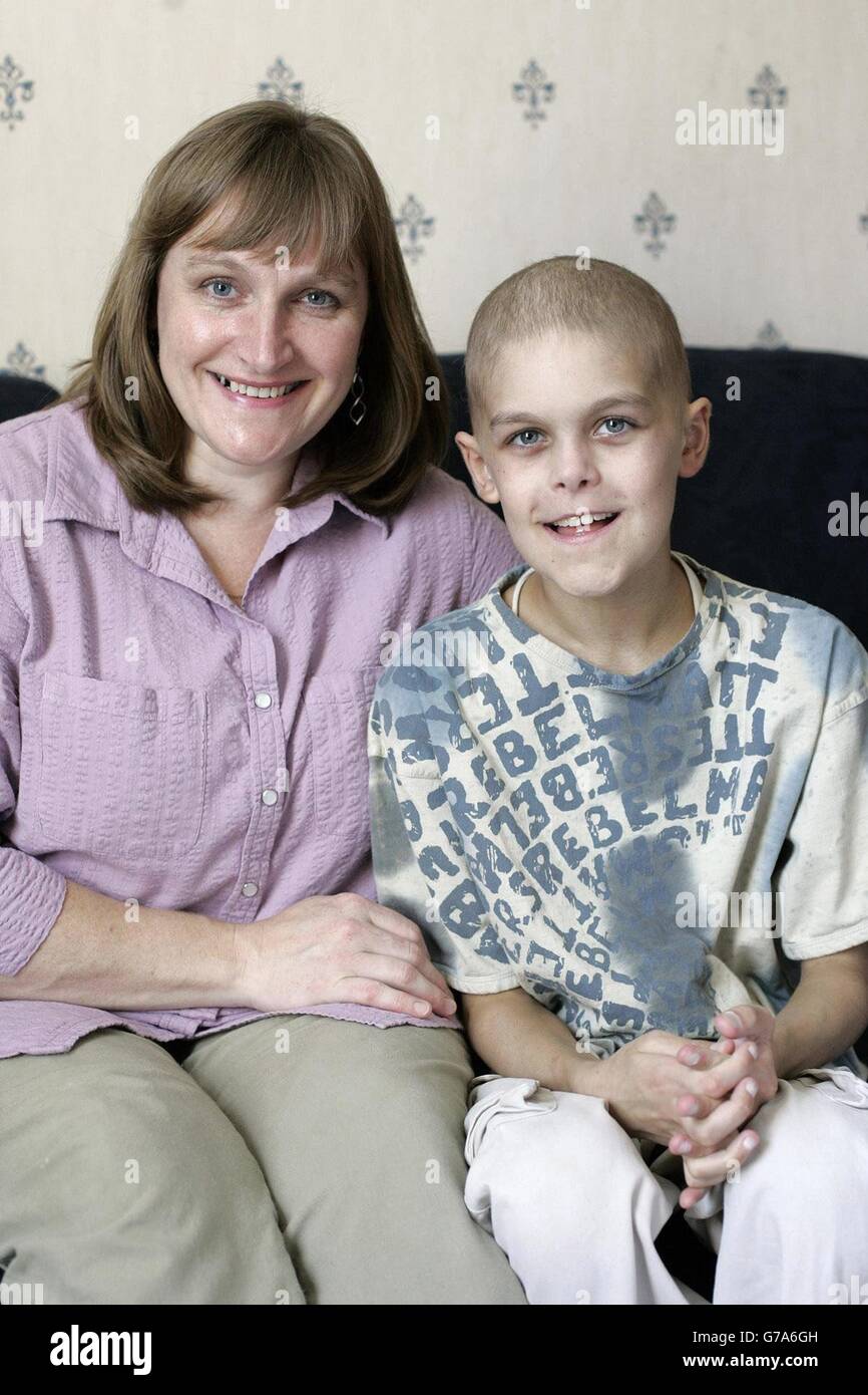 Joshua Hartley sits at his home in Romsey, Hampshire, with his mum
