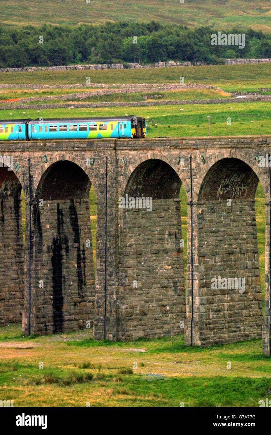 Please be aware that this picture shows a train operated by Arriva Trains Northern, and that from 1 Feb 2004 this franchise is run by Northern Rail. Accordingly, this picture should not be used to illustrate any story relating to Arriva franchises. An Arriva train travels over the Ribblehead viaduct in Cumbria on the Carlisle to Settle railway line. Stock Photo