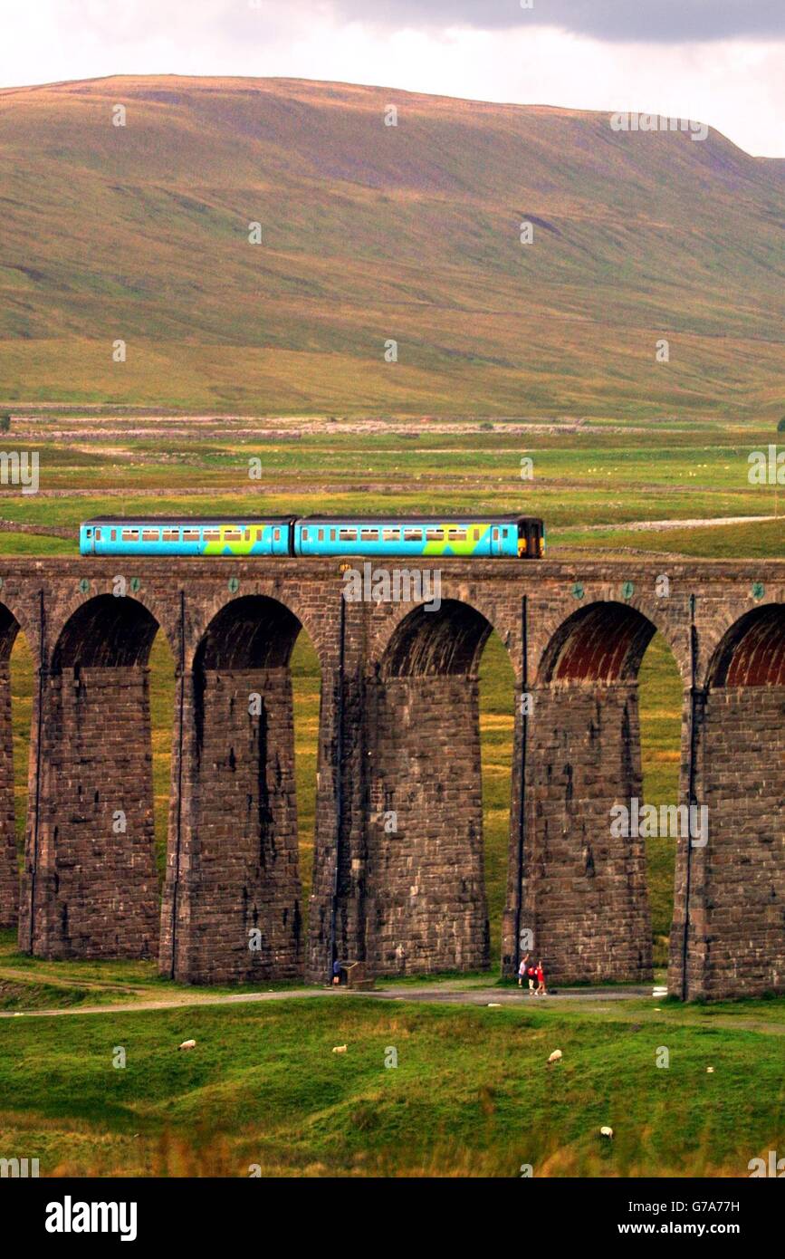 Please be aware that this picture shows a train operated by Arriva Trains Northern, and that from 1 Feb 2004 this franchise is run by Northern Rail. Accordingly, this picture should not be used to illustrate any story relating to Arriva franchises. An Arriva train travels over the Ribblehead viaduct in Cumbria on the Carlisle to Settle railway line. Stock Photo