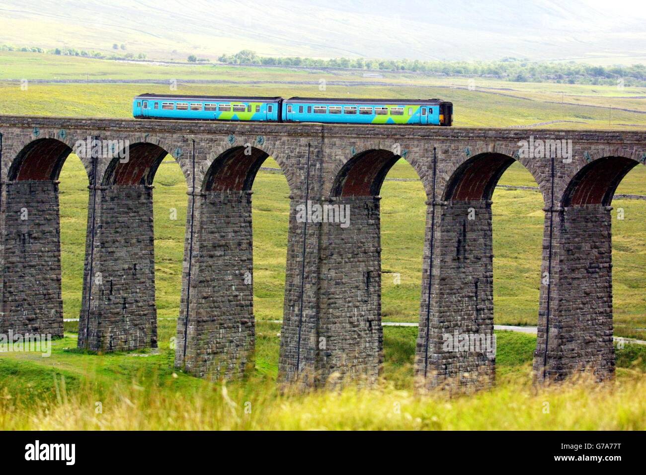 Please be aware that this picture shows a train operated by Arriva Trains Northern, and that from 1 Feb 2004 this franchise is run by Northern Rail. Accordingly, this picture should not be used to illustrate any story relating to Arriva franchises. An Arriva train travels over the Ribblehead viaduct in Cumbria on the Carlisle to Settle railway line. Stock Photo