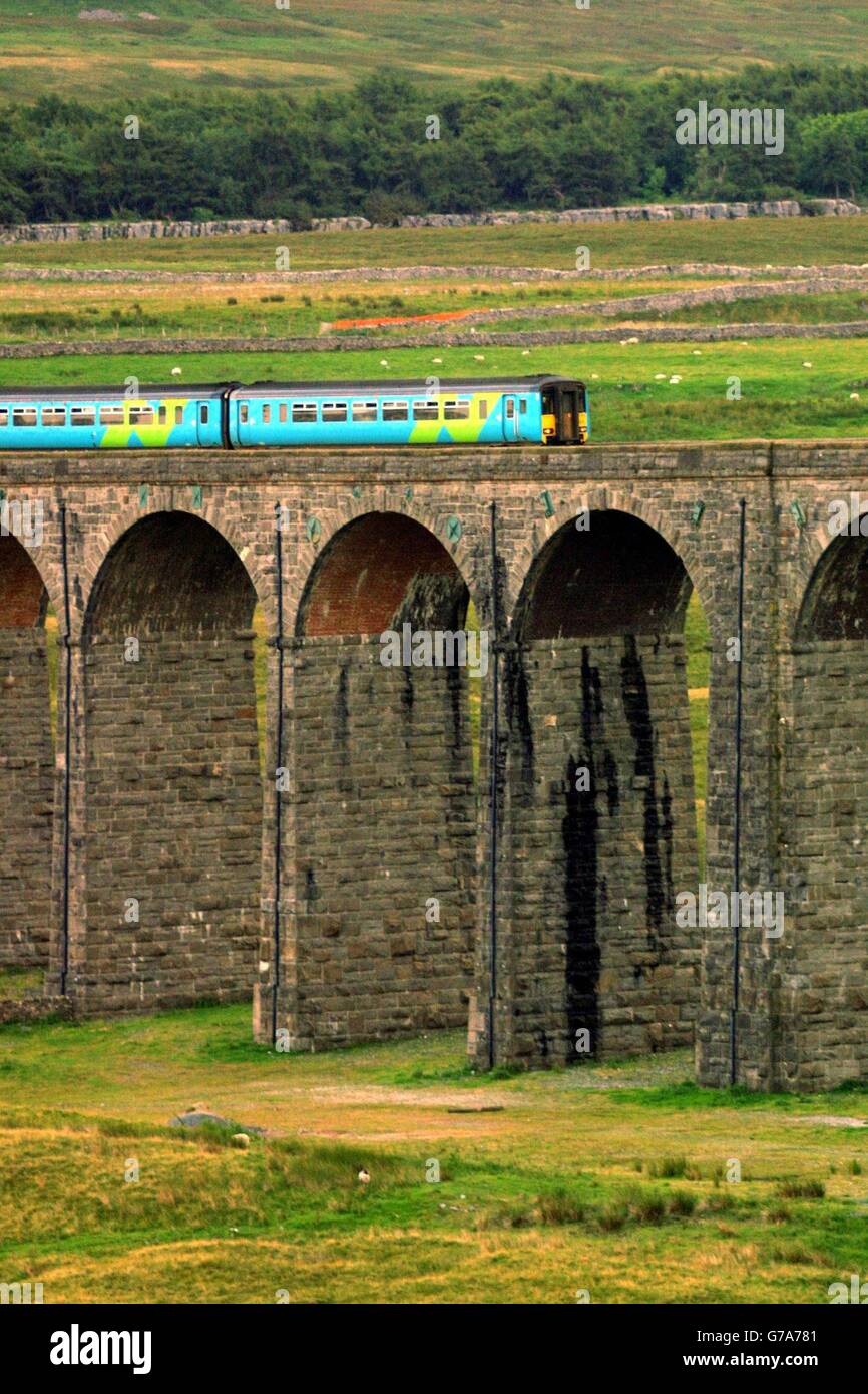 Please be aware that this picture shows a train operated by Arriva Trains Northern, and that from 1 Feb 2004 this franchise is run by Northern Rail. Accordingly, this picture should not be used to illustrate any story relating to Arriva franchises. An Arriva train approaches the Ribblehead viaduct in Cumbria on the Carlisle to Settle railway line. Stock Photo