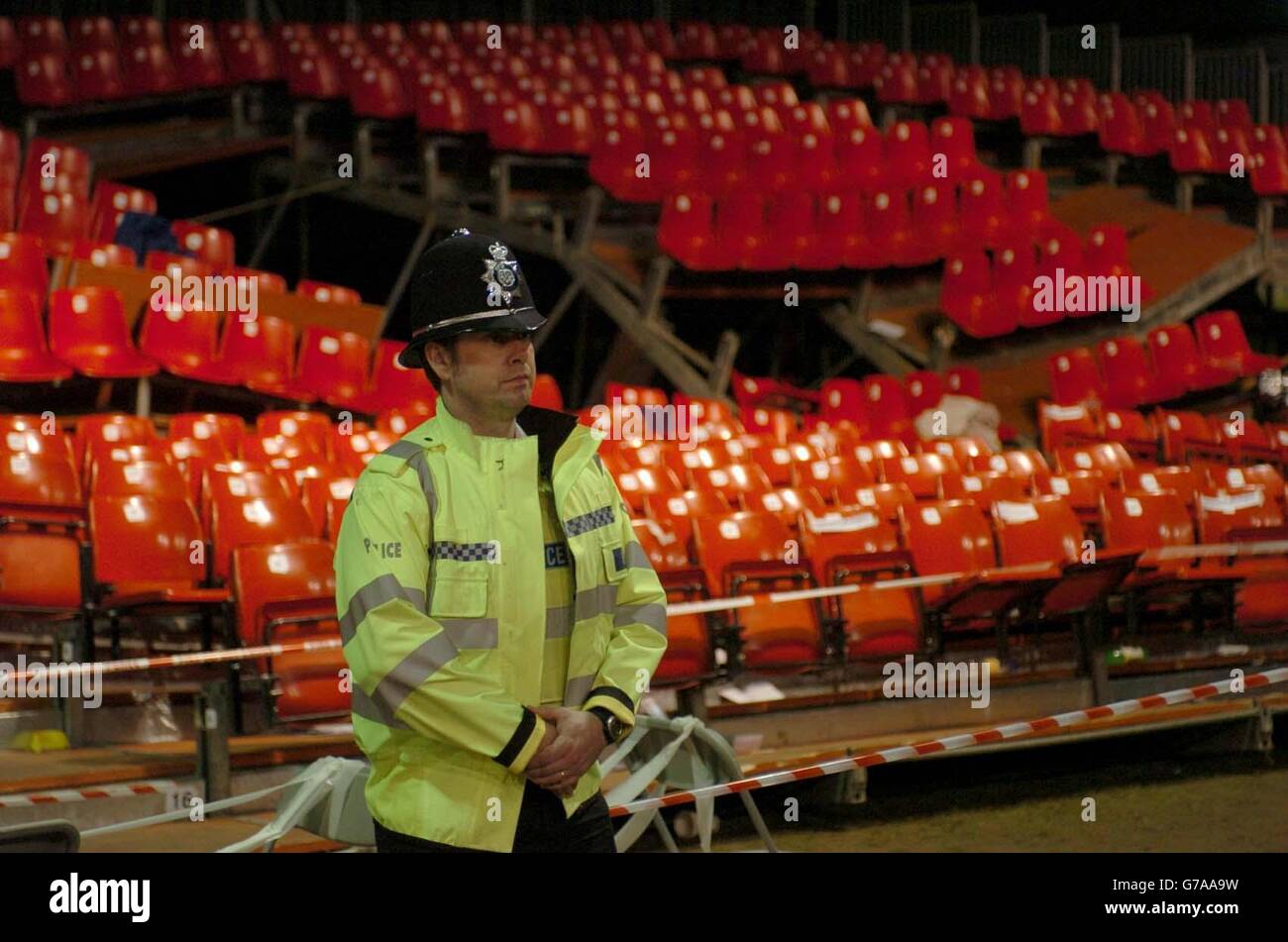 A police officer stands in front of a collapsed seating gallery at the Lincoln showground. The gantry gave way during a pop concert at the Grapevine Christian festival being held on the site. Stock Photo