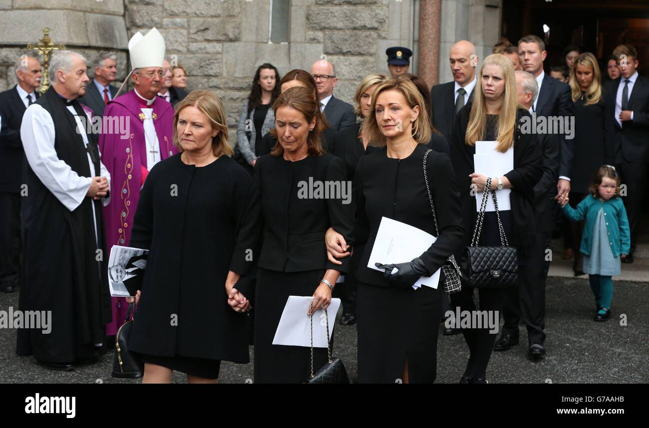 Former Taoiseach Albert Reynolds' daughters (left to right) Miriam, Emer and Leonie follow his coffin following his funeral. Stock Photo