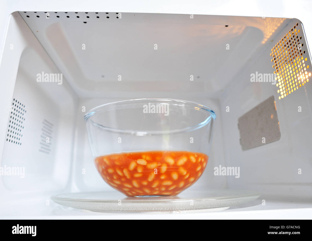 A bowl of baked beans in a microwave cooker Stock Photo Alamy