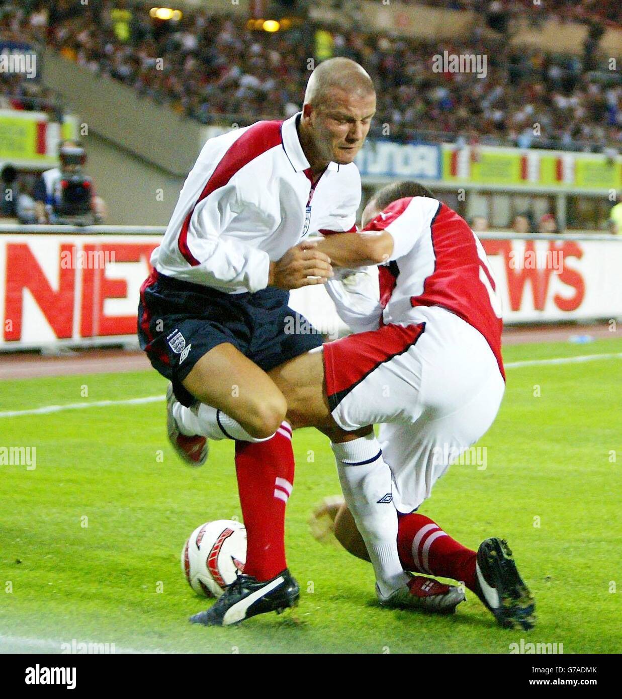 England's David Beckham is challenged by Austria's Emanuel Pogatetz (right) during the World Cup European Qualifying Group Six match, at the Ernst Happel Stadium, Vienna. Stock Photo