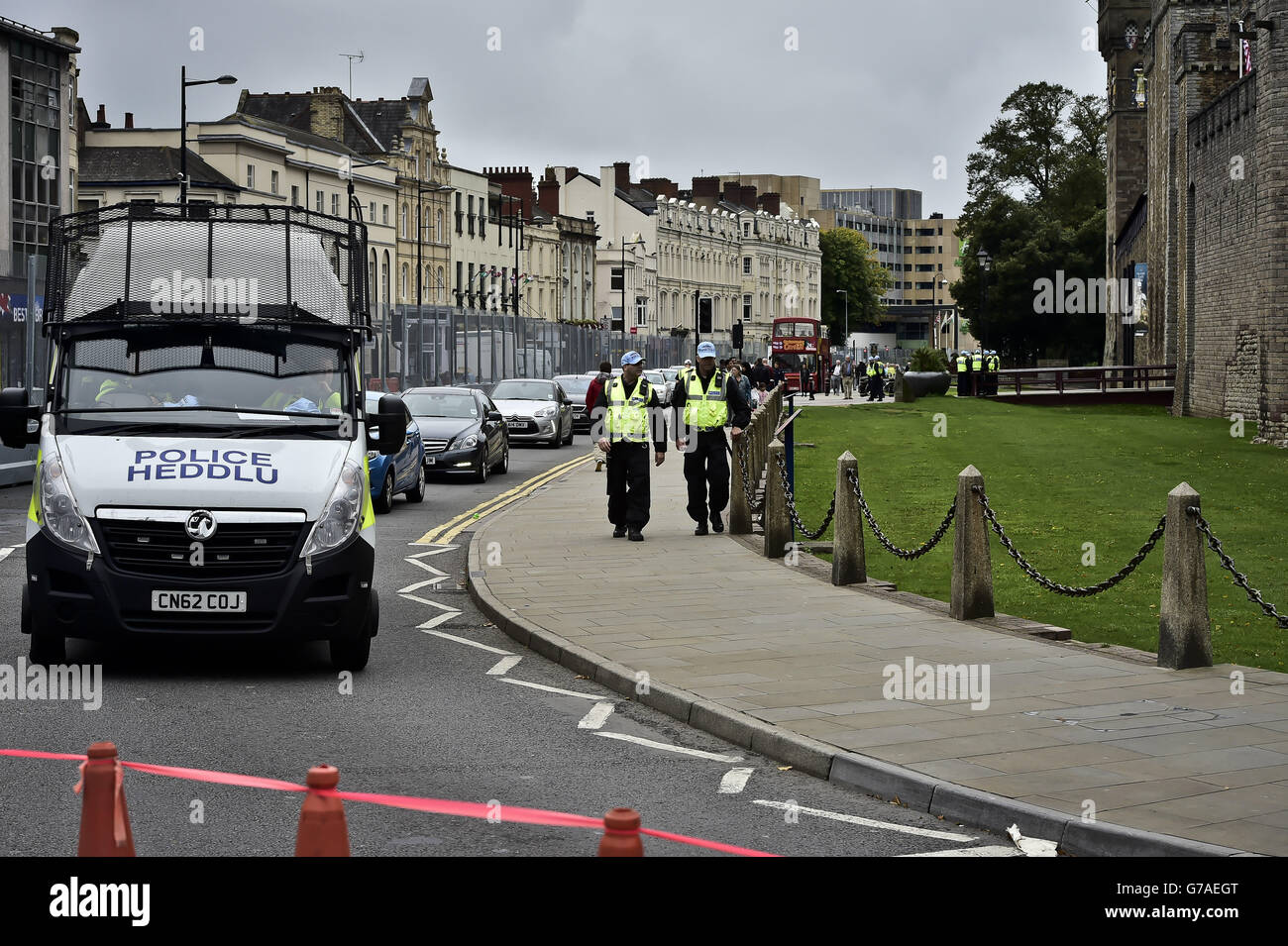 A police presence inside security fencing surrounding Cardiff Castle ahead of the NATO summit in Newport, Wales. Stock Photo