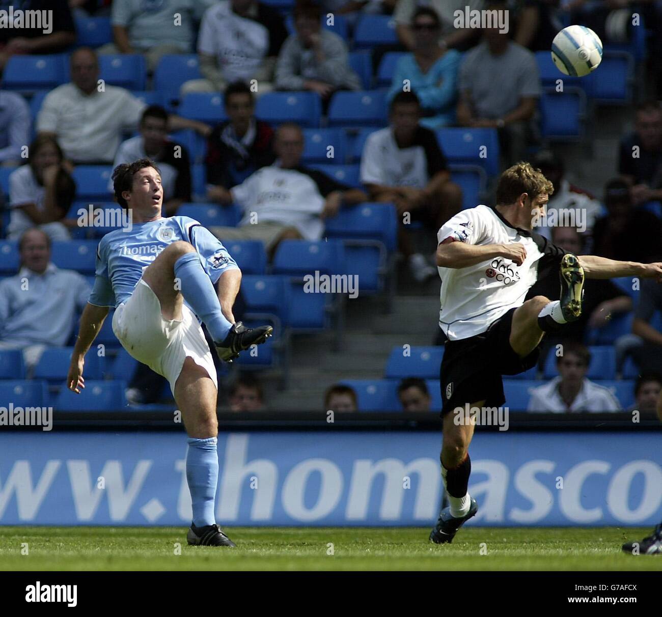 Manchester City's Robbie Fowler (left) scores the opening goal against Fulham during their Barclays Premiership match at the City of Manchester Stadium, Manchester, Saturday August 14, 2004. Stock Photo