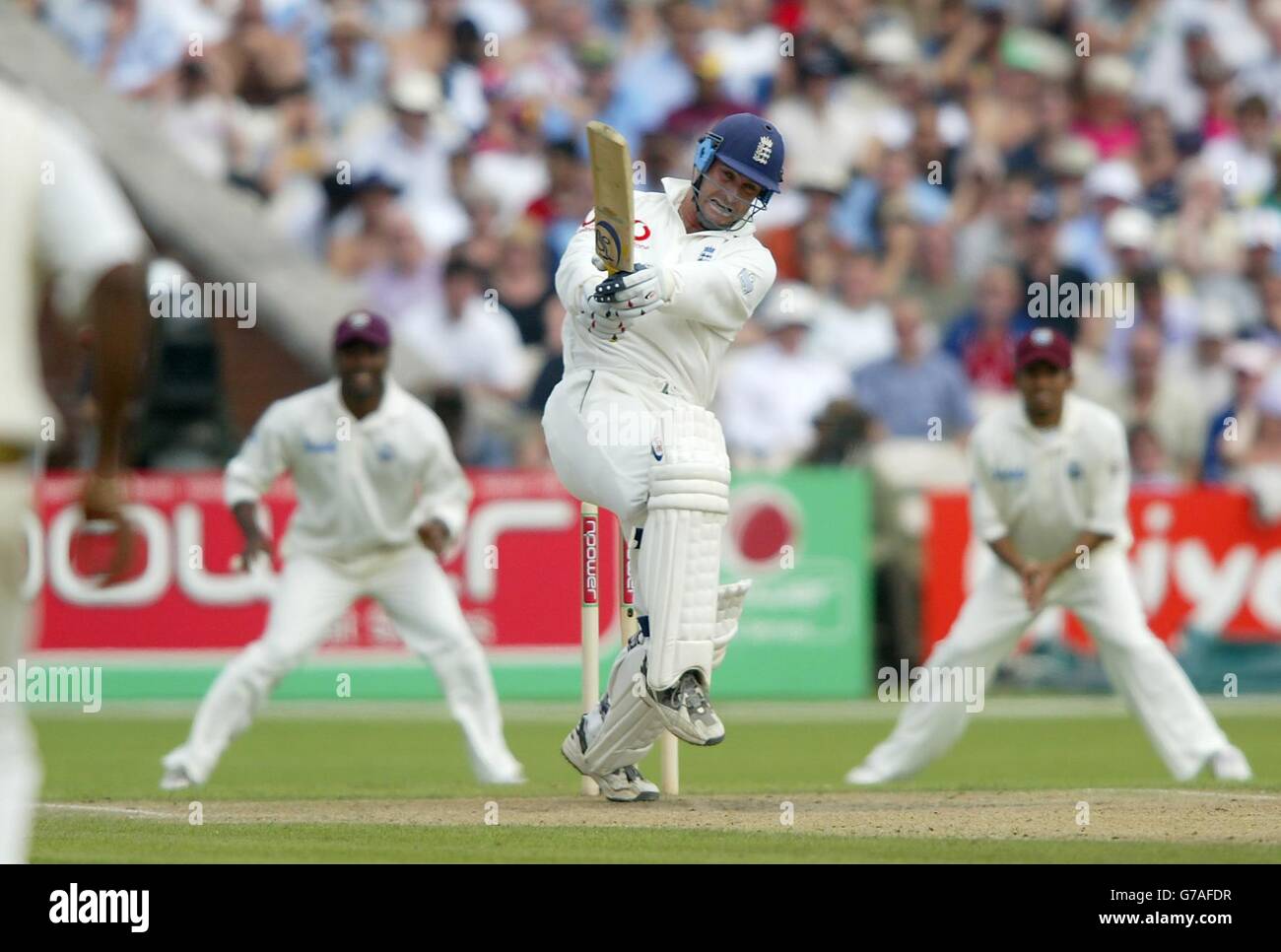 England's Graham Thorpe (centre) hits a boundary against the West Indies during the third day of their third npower test at Old Trafford, Manchester. Stock Photo