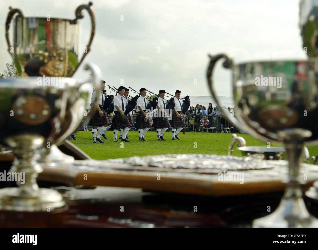 A Canadian pipeband being judged with a selection of trouphies laid out for the winners during the world Pipe Band Championship, Glasgow Green, Scotland. Stock Photo