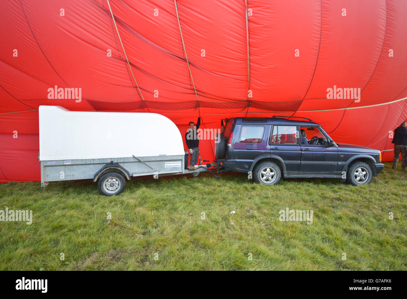 Hot air balloons are inflated ahead of a mass ascent at the 36th International Balloon Fiesta at the Ashton Court Estate near Bristol, which is Europe's largest ballooning event. Stock Photo