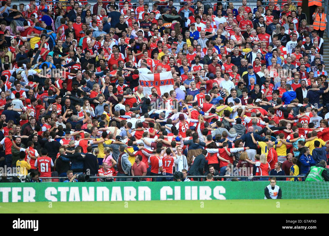 Arsenal fans celebrate by doing the 'Poznan' dance in the stands after their team's third goal during the Community Shield match at Wembley Stadium, London. Stock Photo