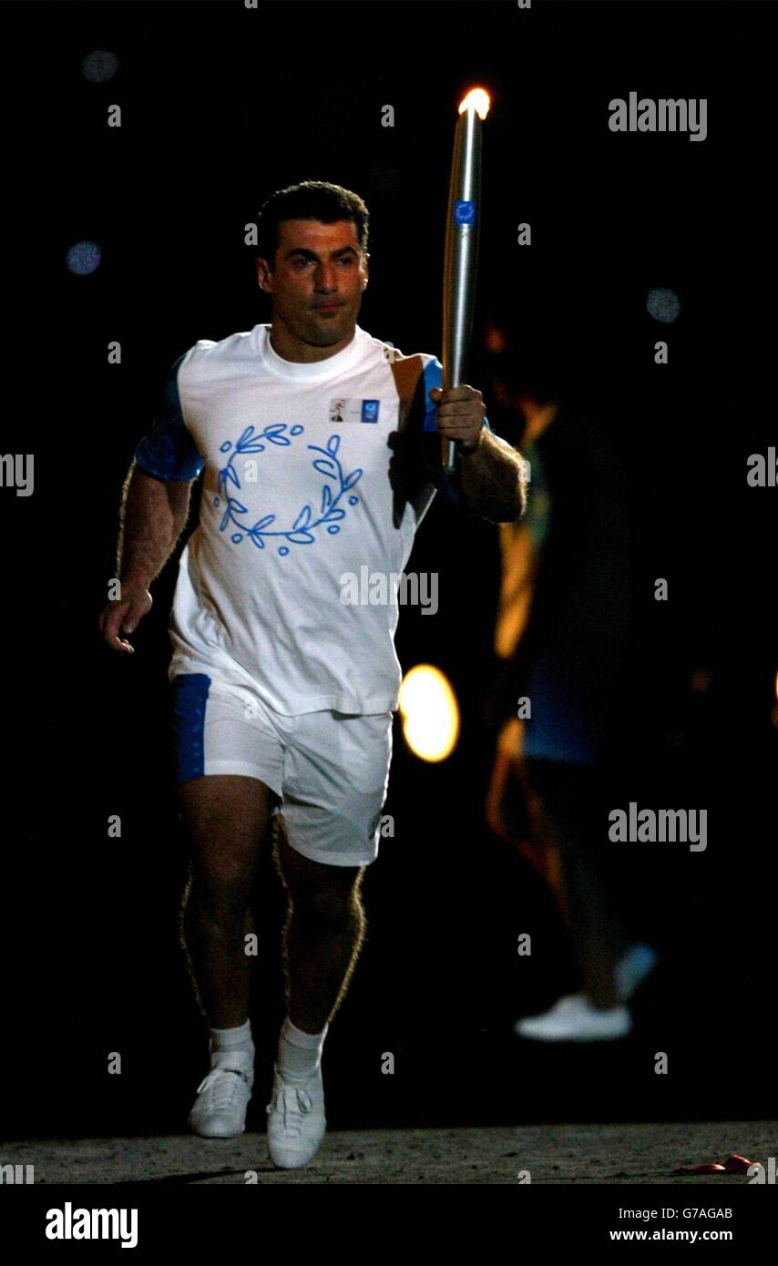 Former Greece Basketball player, Nikos Gallis carries the Olympic torch