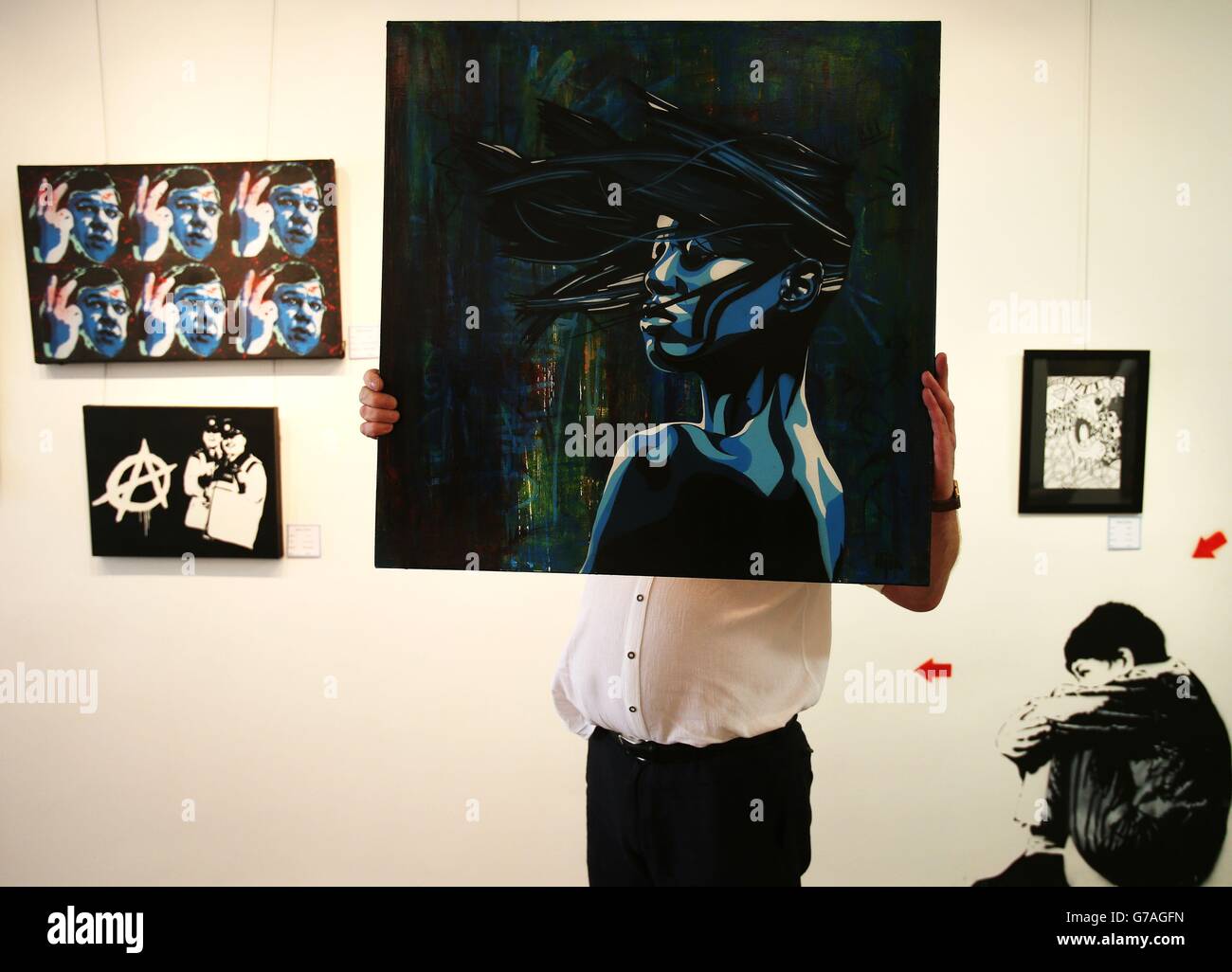 Gallery owner Vincent Kelly displays 'Sultry' by Iljin as part of an exhibition of street art and graffiti entitled 'Street Life' which takes place at Zozimus Gallery on Francis Street, Dublin. Stock Photo
