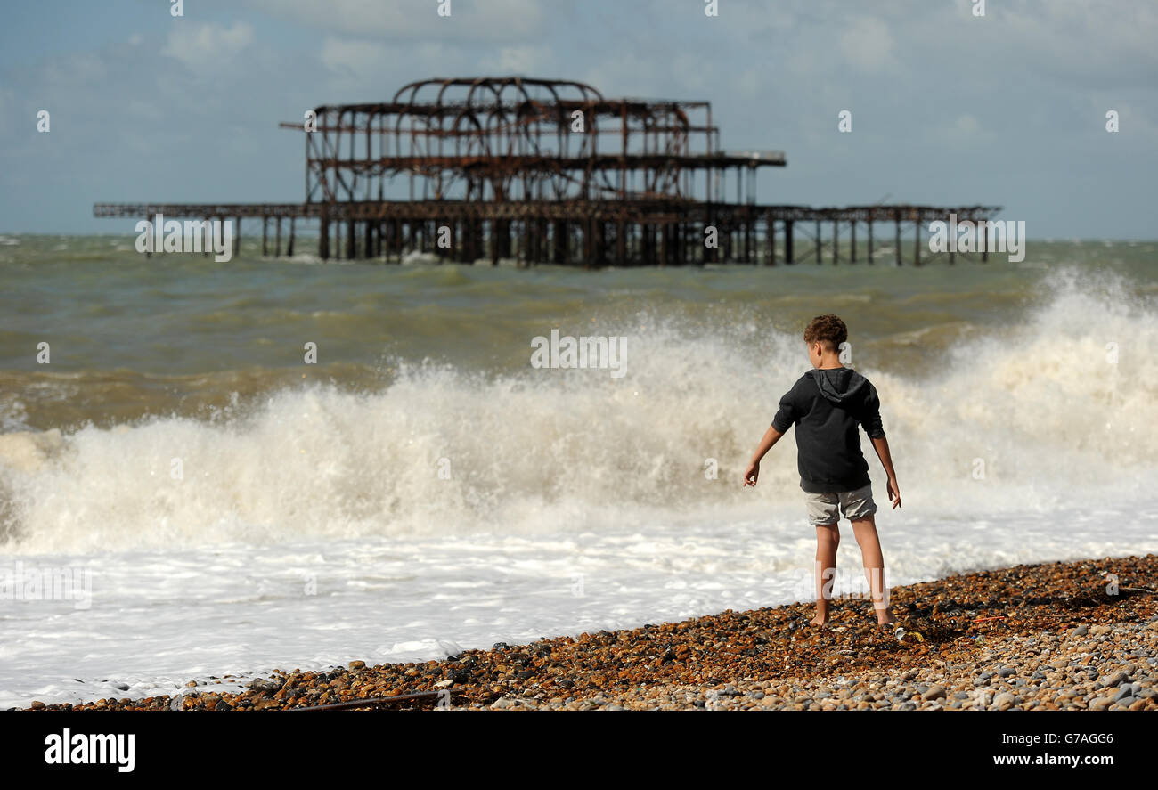 Waves crash on Brighton beach in front of the West pier as the effects of ex-Hurricane Bertha are felt across England and Wales. Stock Photo