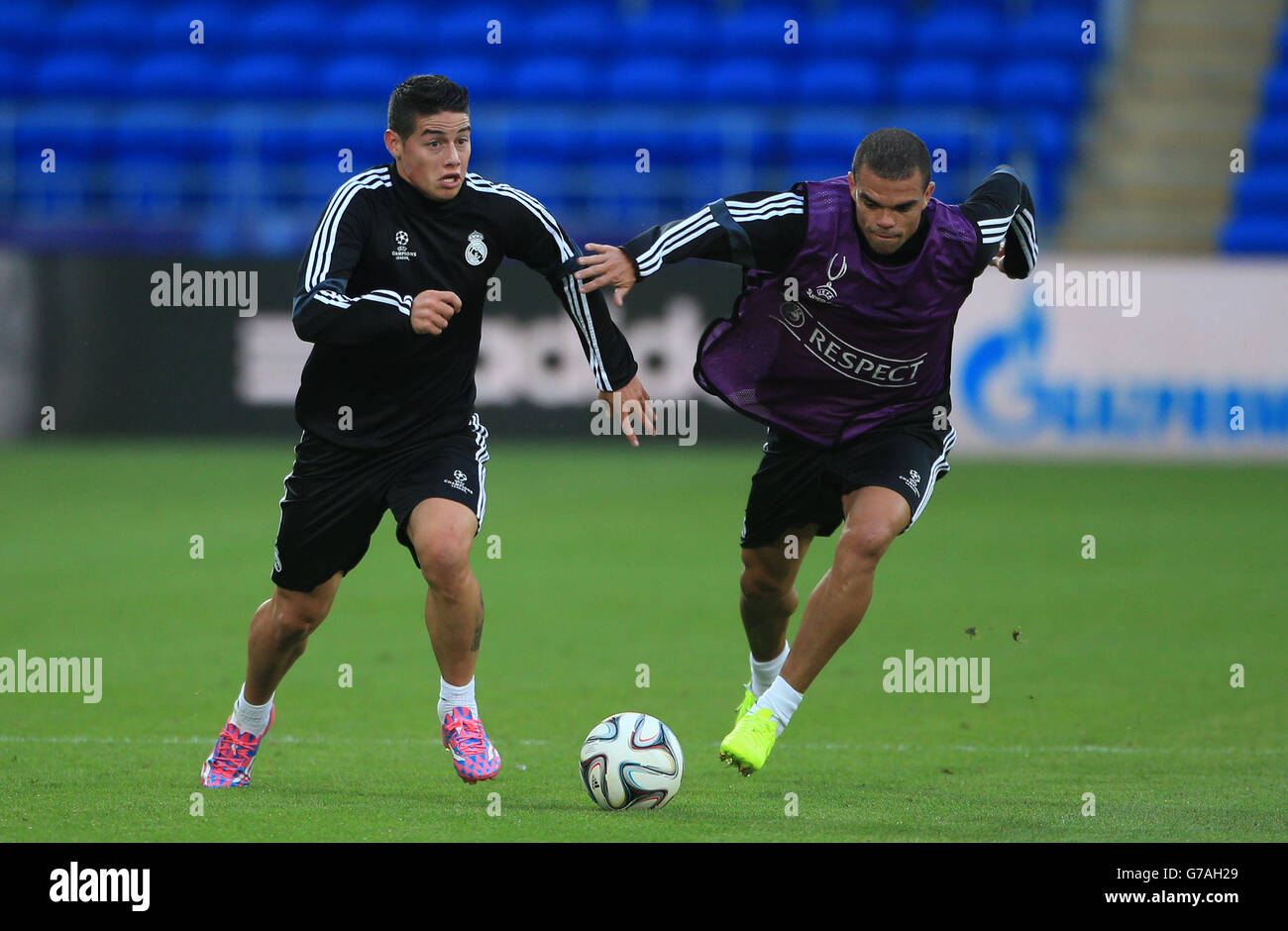 Soccer - 2014 UEFA Super Cup - Sevilla v Real Madrid - Real Madrid Training - Cardiff City Stadium. Real Madrid's James Rodriguez tussles for the ball with Pepe during training at the Cardiff City Stadium, Cardiff. Stock Photo