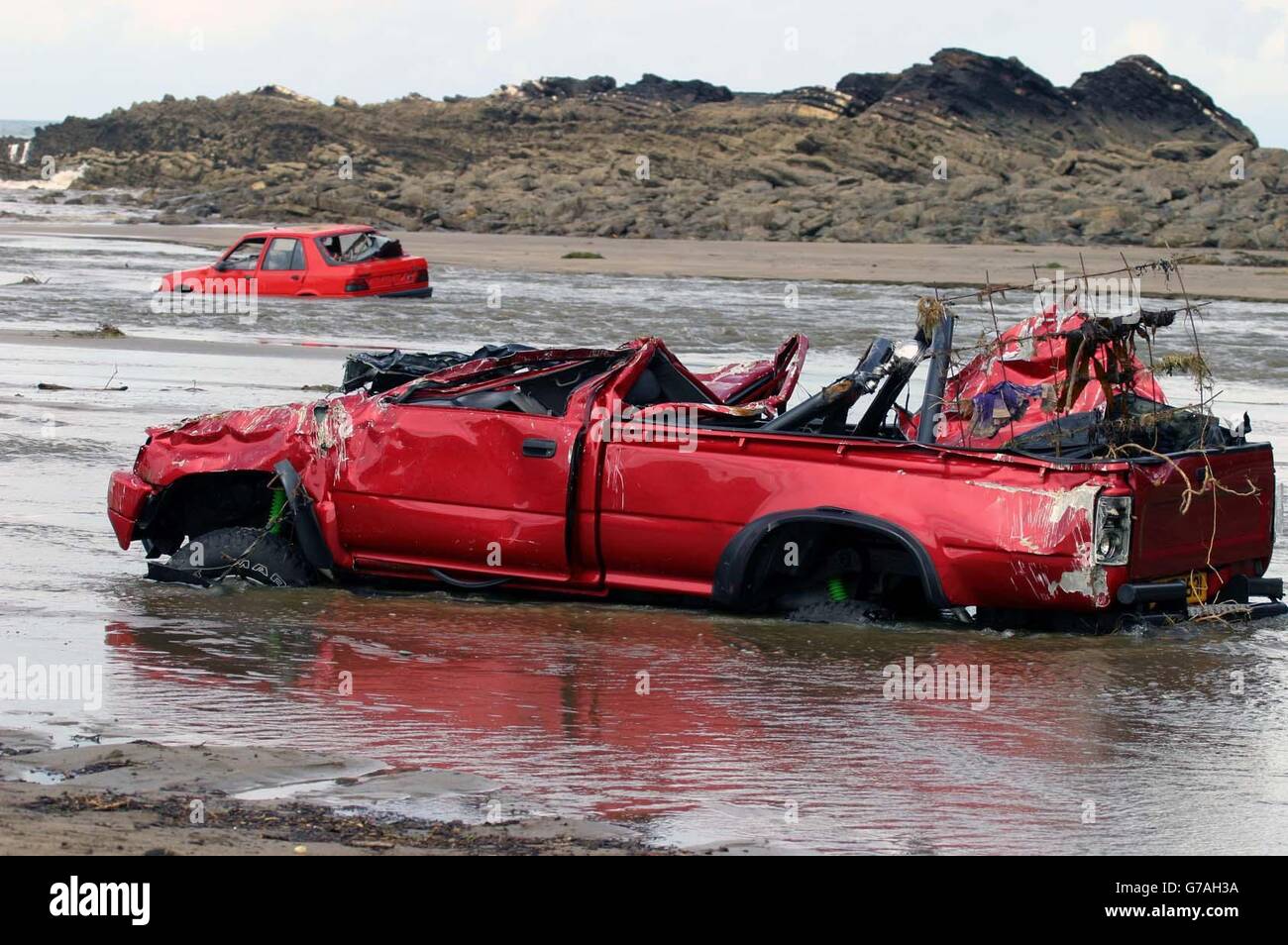Cars washed up on Crackington Haven Beach. Scores of villagers were airlifted to safety after a wall of water tore through the once picturesque north Cornwall town of Boscastle yesterday. Around five inches of rain fell in seven hours in the area and an estimated 3ft of water tore through the streets of the village, which lies in a deep valley leading to the sea. Stock Photo