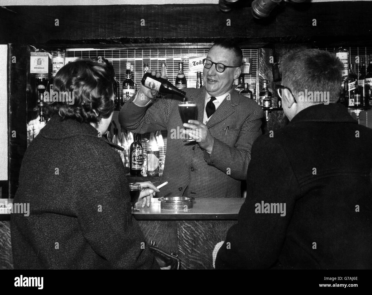 Major Bill Hartley pours a drink Stock Photo