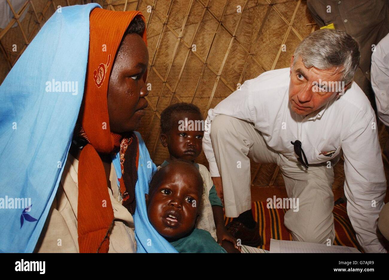 Foreign Secretary Jack Straw meets refugees at the Abu Shouk refugee camp near El Fasher in the Darfur region of northern Sudan. The camp - described by one British official as the 'Hilton' of the Darfur camps - is home to around 57,000 people forced to flee their villages following a campaign of violence by the Arab militias known as the Janjaweed. Mr Straw warned the Sudanese government that it must do more to protect refugees fleeing the violence in Darfur after seeing for himself the conditions in which they are living. Stock Photo