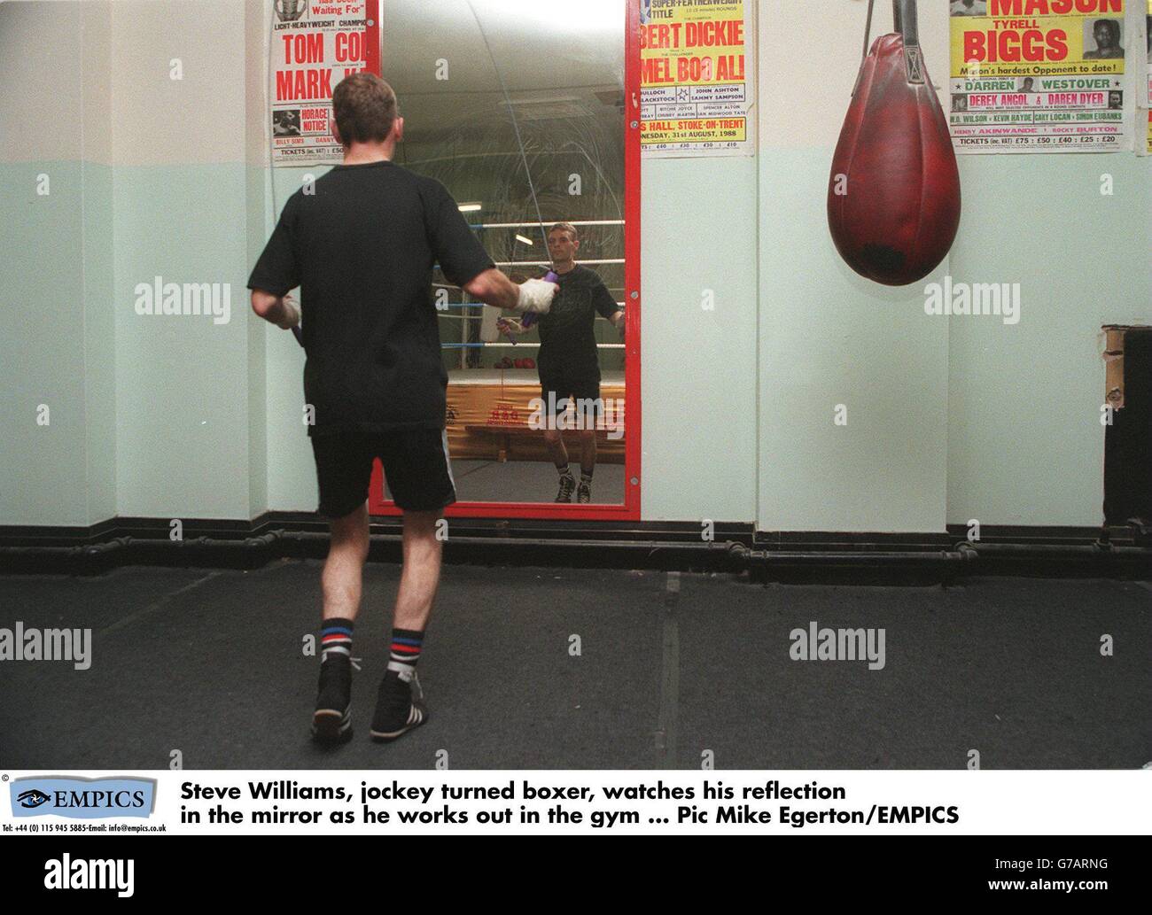 Steve Williams, jockey turned boxer, watches his reflection in the mirror as he works out in the gym Stock Photo