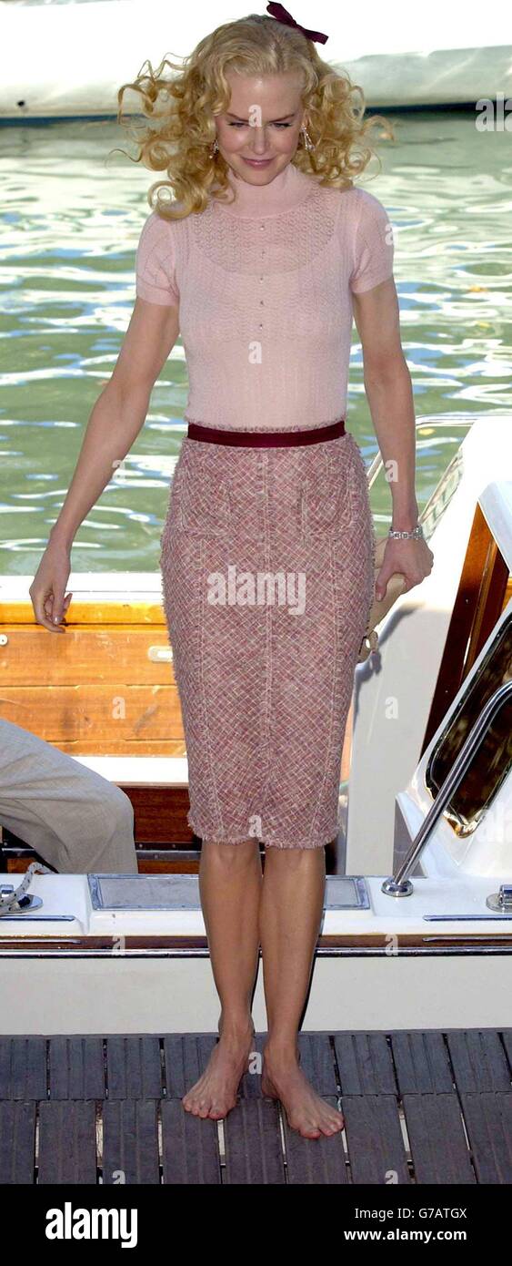 Actress Nicole Kidman walks barefoot as she arrives for a photocall for