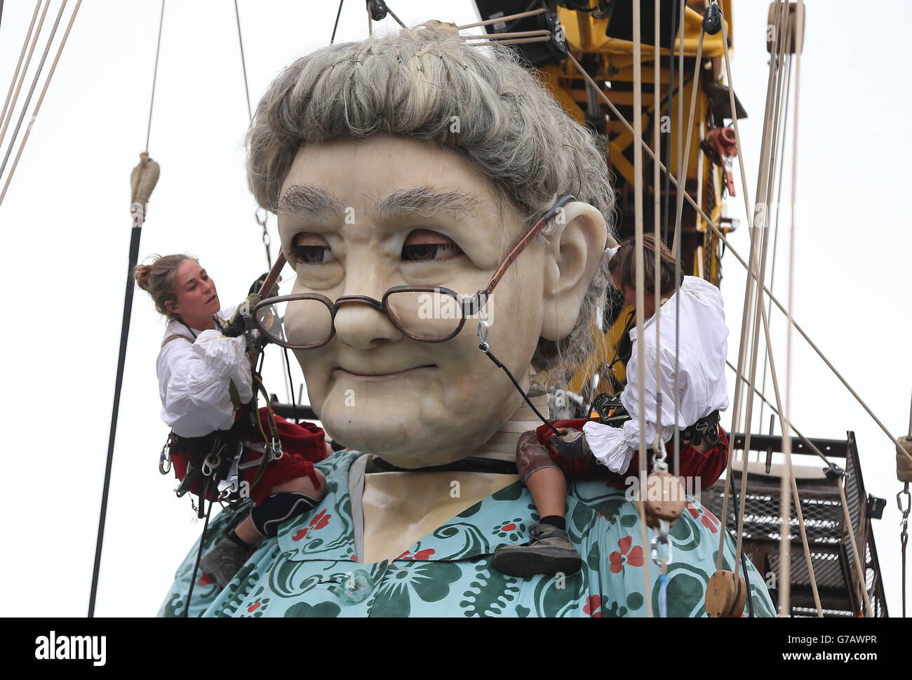 Performers from the French arts group Royal de Luxe adjust the