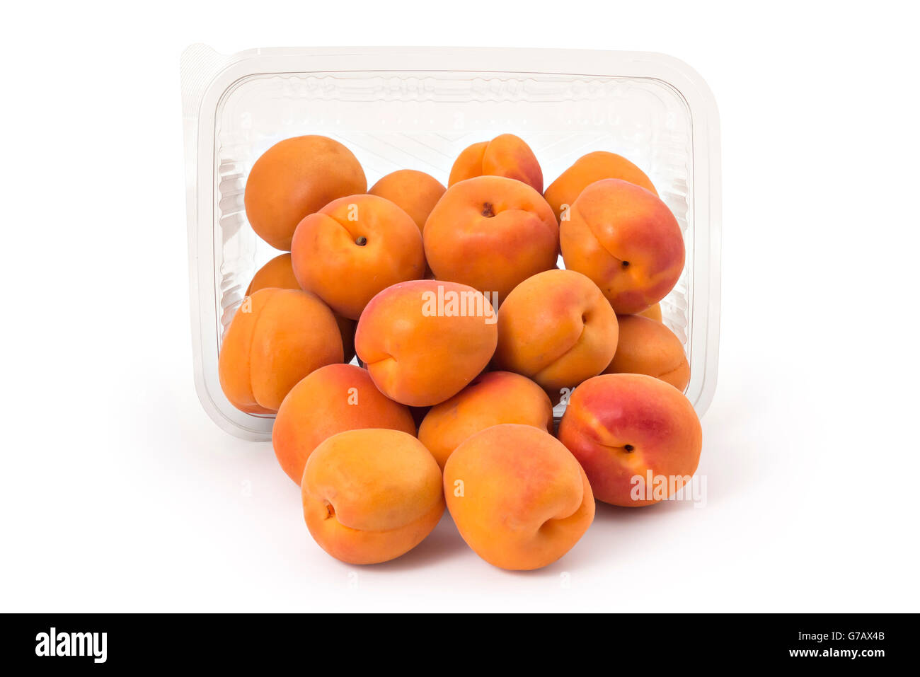 Box or punnet and spilled fresh ripe organic apricots isolated on white ...